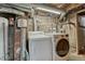 Basement laundry area with exposed piping, washer, and dryer at 1920 S Downing St, Denver, CO 80210