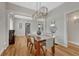 Light filled dining room features open access to the living room and light fixtures for a warm, inviting ambiance at 1920 S Downing St, Denver, CO 80210