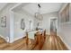 Open dining room shows off hard wood floors and natural light from several entryways and a modern, hanging light fixture at 1920 S Downing St, Denver, CO 80210