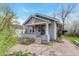 Charming home featuring a classic covered front porch with a cozy and well-kept front yard landscape at 1920 S Downing St, Denver, CO 80210