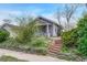 Charming home featuring a covered front porch with a cozy and well-kept front yard landscape at 1920 S Downing St, Denver, CO 80210