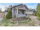 Charming home featuring a covered front porch with a cozy and well-kept front yard landscape with rocks at 1920 S Downing St, Denver, CO 80210
