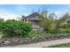 Charming home featuring a covered front porch with a cozy and well-kept front yard landscape with rocks at 1920 S Downing St, Denver, CO 80210