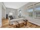 Cozy living room featuring hardwood floors, natural light, and a stylish sofa at 1920 S Downing St, Denver, CO 80210