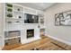 Cozy living room featuring hardwood floors, a fireplace with built-ins, and a television at 1920 S Downing St, Denver, CO 80210