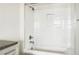 Bright white bathroom features a shower over tub and a recessed niche for storage at 2835 W Parkside Pl # 305, Denver, CO 80221