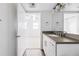Bathroom features a large mirror over a vanity with a gray countertop and modern fixtures at 2835 W Parkside Pl # 305, Denver, CO 80221