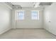 Minimalist bedroom featuring neutral carpet, white walls, exposed ductwork, and large windows for natural light at 2835 W Parkside Pl # 305, Denver, CO 80221
