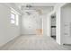 Neutral bedroom featuring neutral carpet, white walls, exposed ductwork, a window, and adjoining bathroom at 2835 W Parkside Pl # 305, Denver, CO 80221