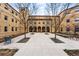 Charming courtyard view framed by bare trees, showcasing the building's architectural symmetry at 2835 W Parkside Pl # 305, Denver, CO 80221
