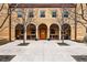 Inviting brick building featuring an arched entryway, seating, and a well-maintained walkway with new concrete at 2835 W Parkside Pl # 305, Denver, CO 80221