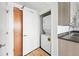 Stacked washer and dryer is located next to sink and cabinet space at 2835 W Parkside Pl # 305, Denver, CO 80221