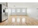 Spacious living area featuring hardwood floors, bright white walls, and large windows for plenty of natural light at 2835 W Parkside Pl # 305, Denver, CO 80221