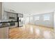 Bright living space featuring hardwood floors, neutral walls, stainless steel appliances, and many windows for natural light at 2835 W Parkside Pl # 305, Denver, CO 80221