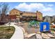 Exterior view of a yellow apartment building with a playground and outdoor gym, providing recreational activities for residents at 2835 W Parkside Pl # 305, Denver, CO 80221