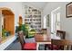 Bright and cozy reading room with built-in bookshelf, a comfortable green armchair, and a wooden table with chairs at 2835 W Parkside Pl # 305, Denver, CO 80221