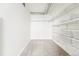 Bright walk-in closet featuring carpeted floors and multiple levels of wire rack shelving for optimal storage and organization at 2835 W Parkside Pl # 305, Denver, CO 80221