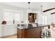 Modern kitchen with white cabinets, dark countertops, and a large island at 7310 S Eudora Way, Centennial, CO 80122