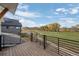 Relax on the outdoor deck, overlooking a manicured lawn, water feature, and distant mountains at 933 Saint Andrews Ln, Louisville, CO 80027