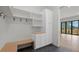 Functional mudroom with bench seating, shelving, storage, and slate flooring at 933 Saint Andrews Ln, Louisville, CO 80027
