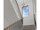 Striking staircase with modern chandelier, carpeted steps, and black railing at 933 Saint Andrews Ln, Louisville, CO 80027
