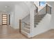 Bright staircase with carpeted steps, black railing, and modern style at 933 Saint Andrews Ln, Louisville, CO 80027