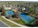 Aerial view of community tennis courts amidst lush greenery, inviting residents to enjoy outdoor activities and social gatherings at 933 Saint Andrews Ln, Louisville, CO 80027