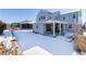 Snowy backyard with a view of the house and surrounding landscape at 4911 Colorado River Dr, Firestone, CO 80504
