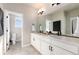 Modern bathroom with double vanity and large mirror at 4911 Colorado River Dr, Firestone, CO 80504