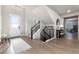 Bright and spacious entryway with modern staircase and wood flooring at 4911 Colorado River Dr, Firestone, CO 80504