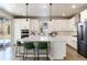 Modern kitchen with white cabinets, large island, and stainless steel appliances at 4911 Colorado River Dr, Firestone, CO 80504