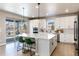 Modern kitchen with white cabinets, large island, and sliding door to backyard at 4911 Colorado River Dr, Firestone, CO 80504