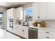 Modern kitchen with white cabinets, stainless steel appliances, and subway tile backsplash at 4911 Colorado River Dr, Firestone, CO 80504