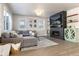 Open concept living room featuring a modern fireplace and large sectional sofa at 4911 Colorado River Dr, Firestone, CO 80504
