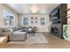 Open concept living room featuring a modern fireplace and large sectional sofa at 4911 Colorado River Dr, Firestone, CO 80504