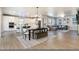 Spacious living and dining area with hardwood floors, modern furniture, and large windows at 4911 Colorado River Dr, Firestone, CO 80504