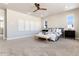 Main bedroom with windows, carpet, and ceiling fan at 4911 Colorado River Dr, Firestone, CO 80504