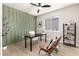 Home office with green accent wall, desk, and comfortable seating at 4911 Colorado River Dr, Firestone, CO 80504