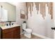 Modern powder room with wood vanity and unique wall detail at 4911 Colorado River Dr, Firestone, CO 80504