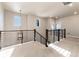 Spacious upstairs hallway with a modern light fixture and railing at 4911 Colorado River Dr, Firestone, CO 80504