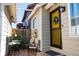Inviting back patio area with outdoor seating and a decorative yellow door entrance at 19044 E 16Th Ave, Aurora, CO 80011