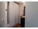Cozy bathroom with a shower-tub combo, dark vanity, and hardwood-style flooring at 19044 E 16Th Ave, Aurora, CO 80011