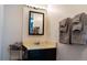 Bathroom with a classic vanity, mirrored cabinet, and neatly arranged gray towels at 19044 E 16Th Ave, Aurora, CO 80011