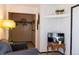 Bedroom featuring a comfortable chair, closet, and television area for rest and relaxation at 19044 E 16Th Ave, Aurora, CO 80011