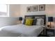 Comfortable bedroom with stylish wall art, bedside lamps, and a plush-looking bed at 19044 E 16Th Ave, Aurora, CO 80011