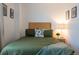 Cozy bedroom featuring a comfortable bed, a decorative floral pillow, and soft, inviting lighting at 19044 E 16Th Ave, Aurora, CO 80011