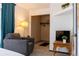 Bedroom featuring a comfortable chair, closet, and television area for rest and relaxation at 19044 E 16Th Ave, Aurora, CO 80011