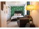 Comfortable bedroom with accent wallpaper, large chair, and soft lighting for a relaxing ambiance at 19044 E 16Th Ave, Aurora, CO 80011