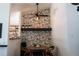 Charming dining area featuring a round wooden table, accent wall, and modern ceiling fan at 19044 E 16Th Ave, Aurora, CO 80011
