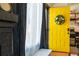 Charming entryway with a bright yellow door adorned with a wreath and a glimpse into the modern kitchen at 19044 E 16Th Ave, Aurora, CO 80011